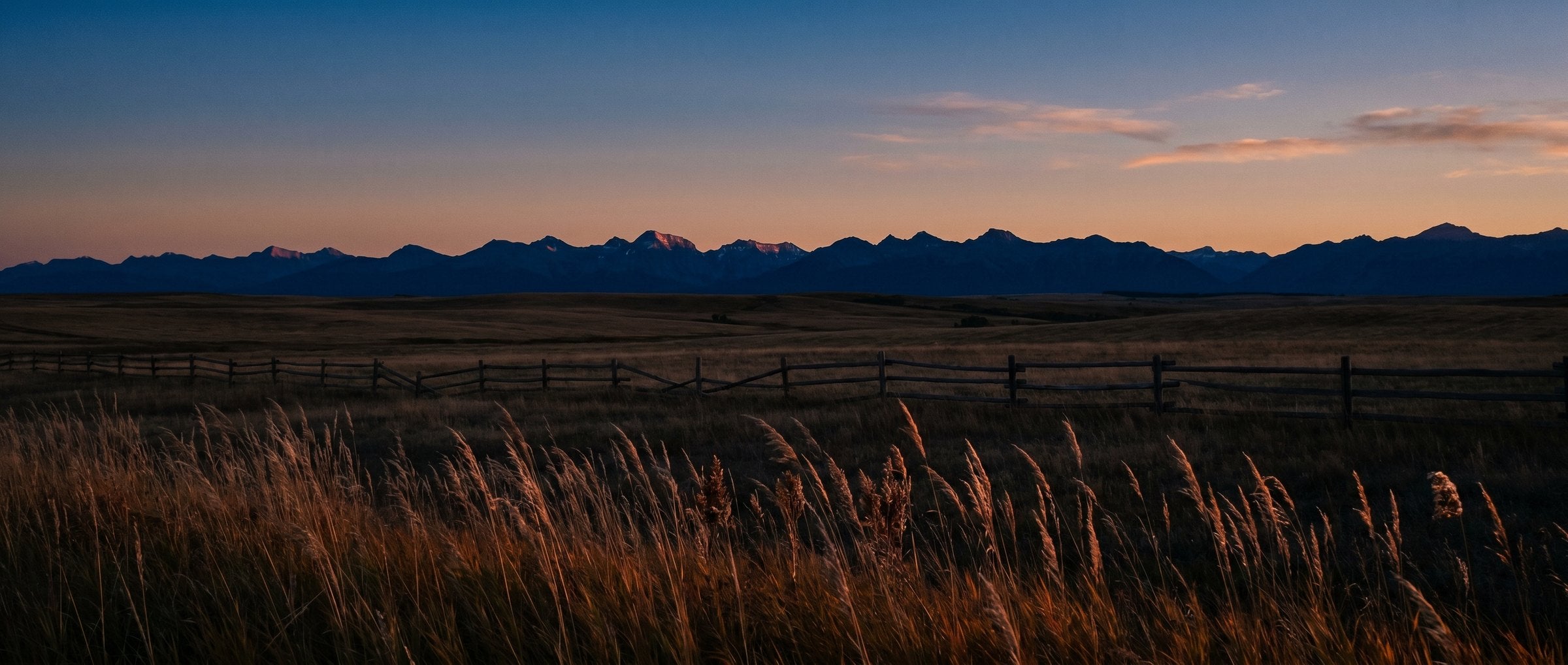 Alberta prairie at dusk, the Rockies in silhouette